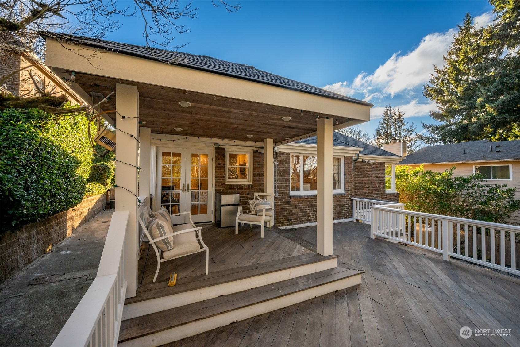 312 Northeast 95th Street Seattle, WA 98115 - Photo 29 of 37 a view of a patio with table and chairs with wooden floor and fence