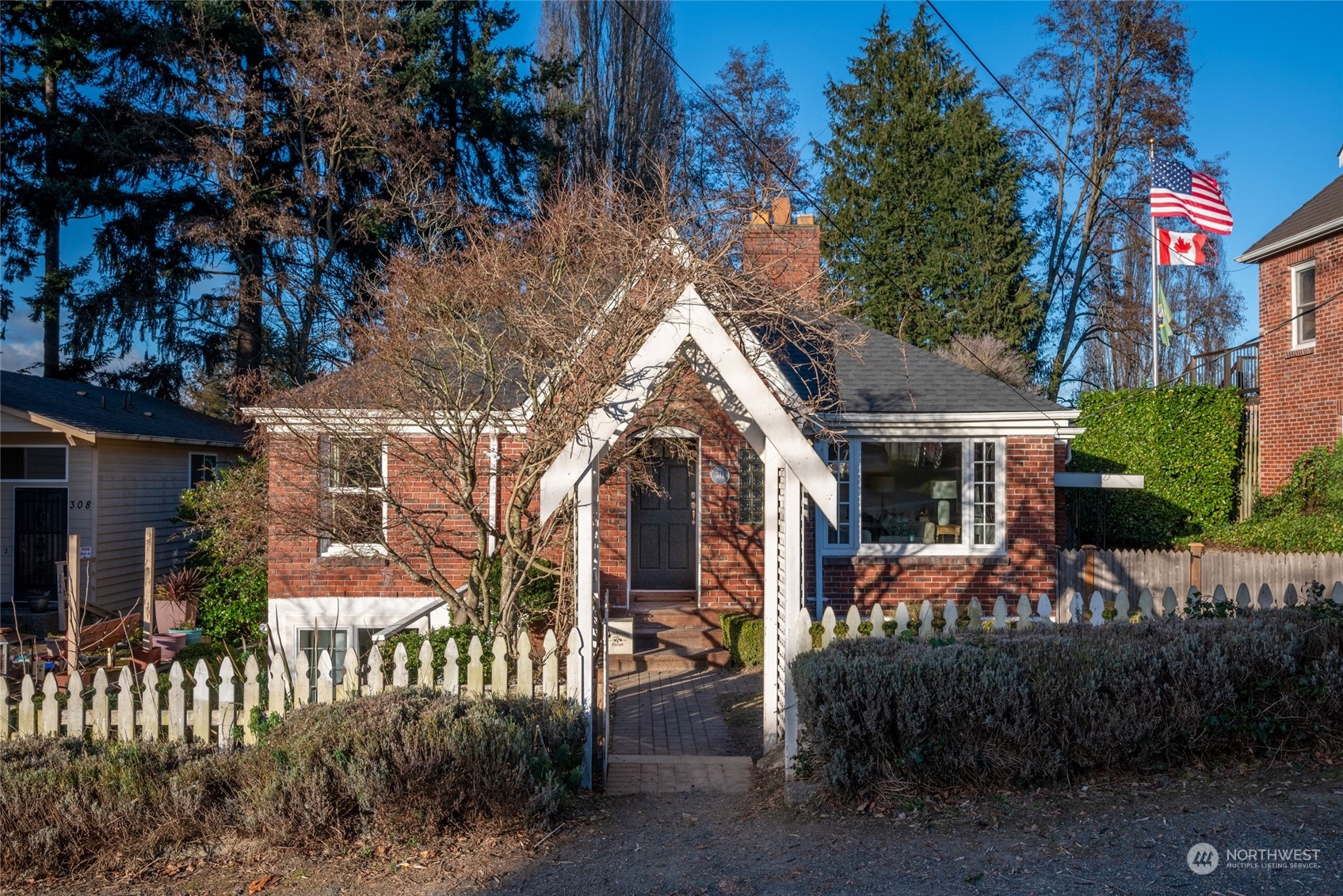 312 Northeast 95th Street Seattle, WA 98115 - Photo 35 of 37 a view of a brick house with large windows and a small yard
