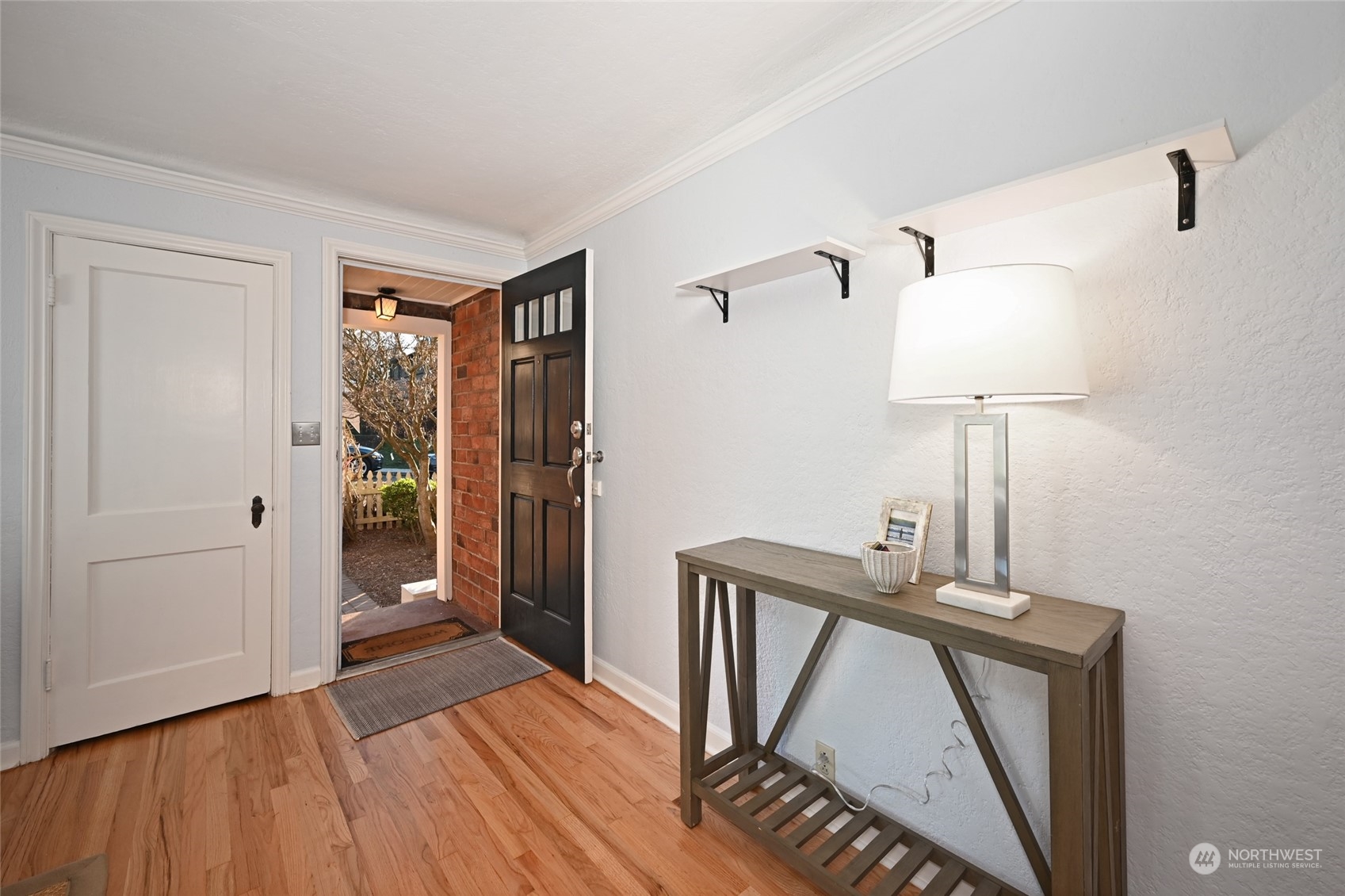 312 Northeast 95th Street Seattle, WA 98115 - Photo 6 of 37 a view of a hallway with wooden floor and workspace