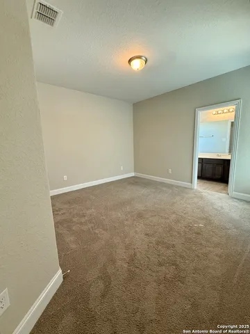 an empty room with a kitchen