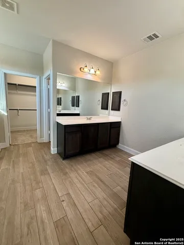 a view with kitchen island wooden floor and living room