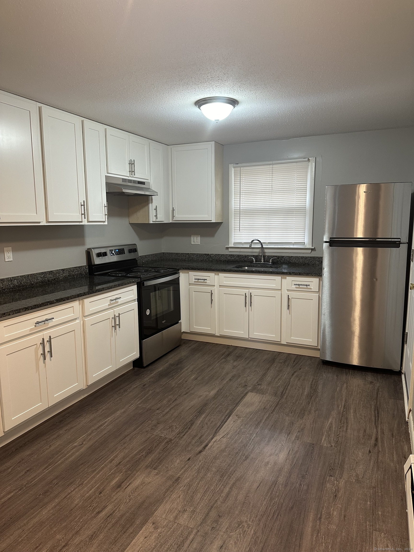 191 Queen Street, Unit A7 Southington, CT 06489 - Photo 1 of 1 a kitchen with stainless steel appliances white cabinets a sink a stove a refrigerator and white cabinets