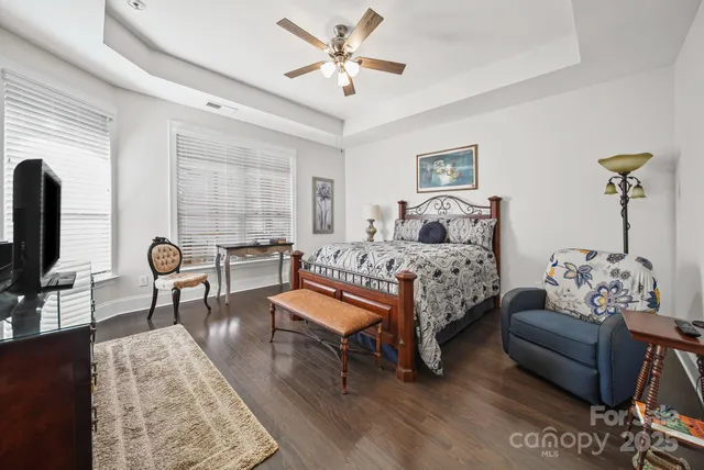 a bedroom with furniture and a large window