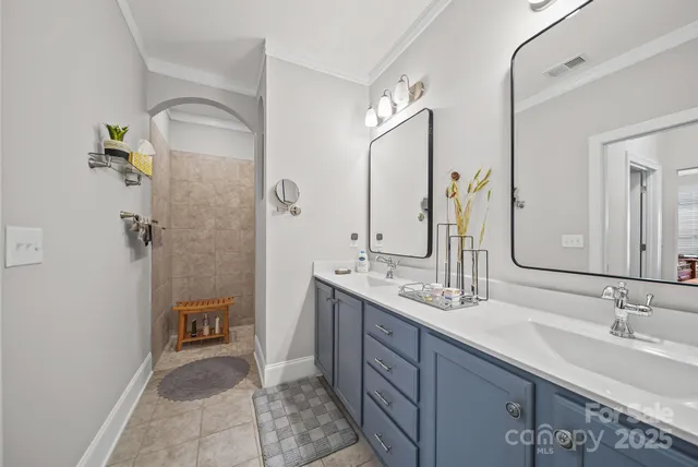 a bathroom with a double vanity sink and a mirror