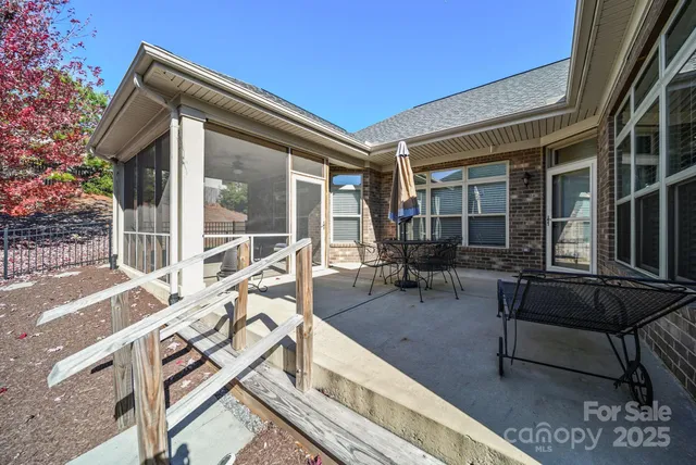 a pathway of a house with potted plants