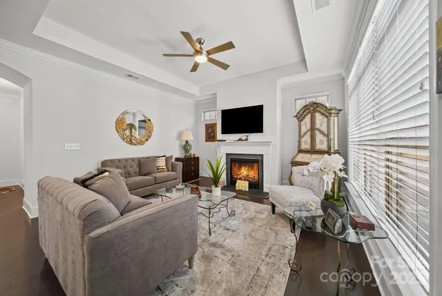 a living room with furniture a fireplace and a flat screen tv