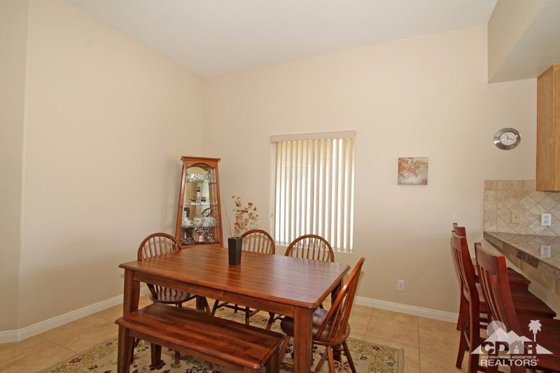 56 Oak Tree Drive Rancho Mirage, CA 92270 - Photo 11 of 32 a view of a dining room with furniture and window
