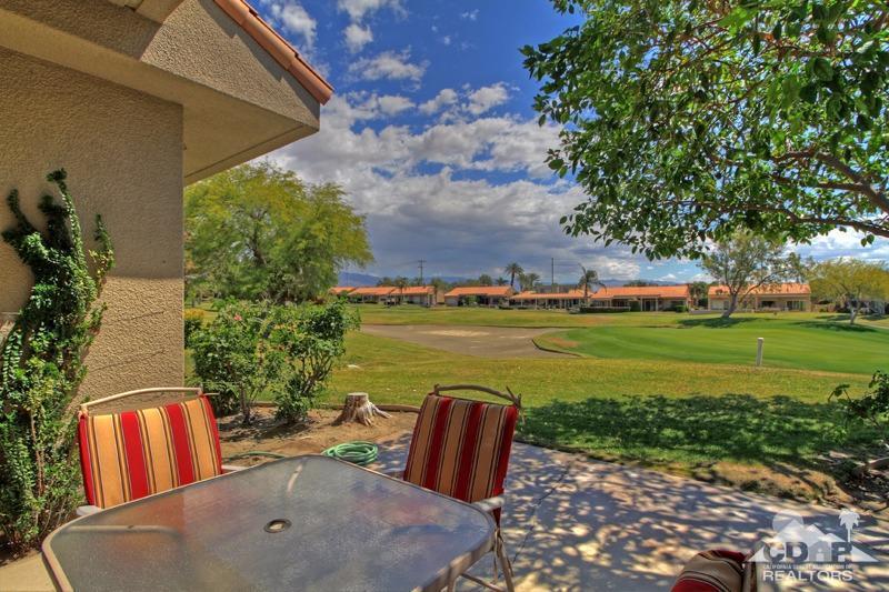 56 Oak Tree Drive Rancho Mirage, CA 92270 - Photo 13 of 32 a backyard of a house with table and chairs