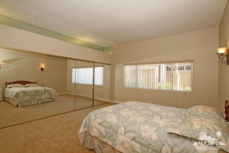 56 Oak Tree Drive Rancho Mirage, CA 92270 - Photo 15 of 32 a bedroom with a bed and a window