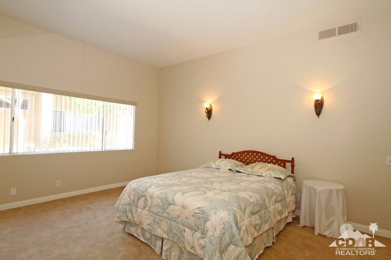 56 Oak Tree Drive Rancho Mirage, CA 92270 - Photo 16 of 32 a bedroom with a bed and a window