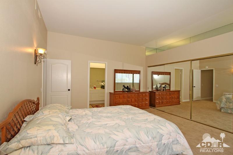56 Oak Tree Drive Rancho Mirage, CA 92270 - Photo 17 of 32 a bedroom with a bed and a dresser in it