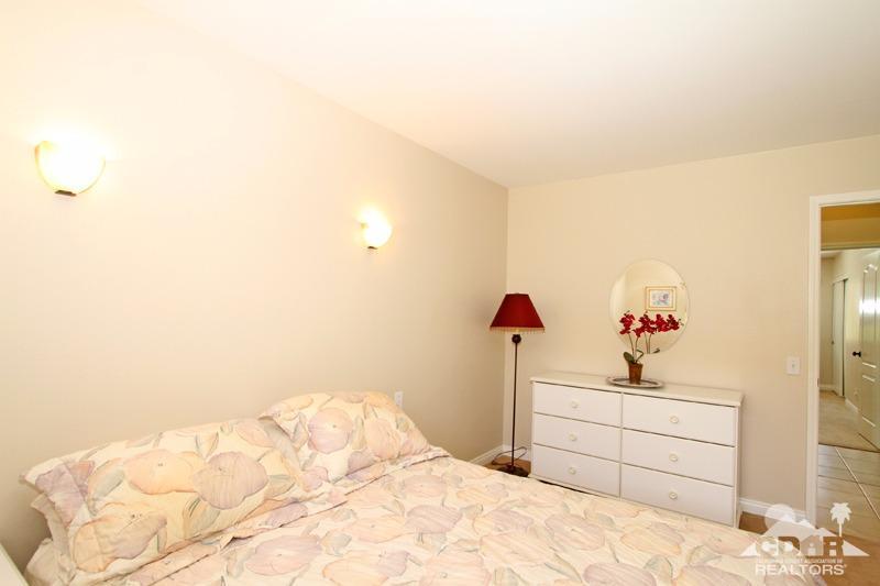 56 Oak Tree Drive Rancho Mirage, CA 92270 - Photo 19 of 32 a bedroom with a bed and a cabinets