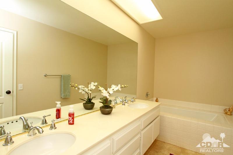 56 Oak Tree Drive Rancho Mirage, CA 92270 - Photo 20 of 32 a bathroom with a granite countertop sink and a mirror