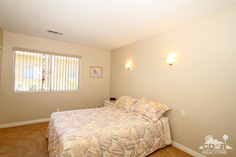 56 Oak Tree Drive Rancho Mirage, CA 92270 - Photo 22 of 32 a bedroom with a bed and a window