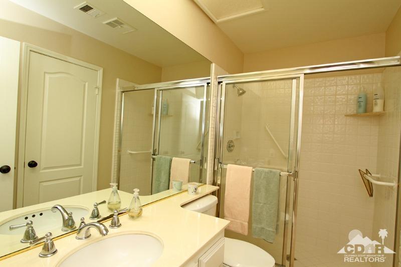 56 Oak Tree Drive Rancho Mirage, CA 92270 - Photo 23 of 32 a bathroom with a sink and mirror with bathtub