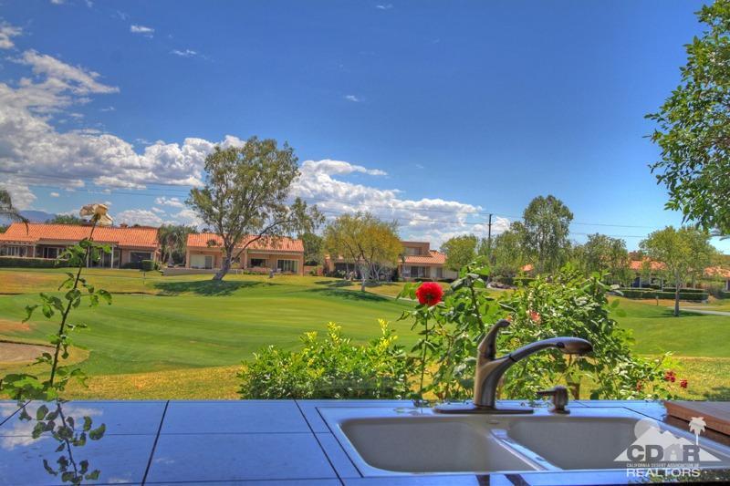 56 Oak Tree Drive Rancho Mirage, CA 92270 - Photo 3 of 32 a view of a garden with a lake