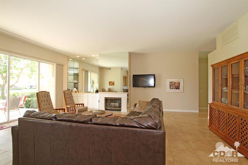 56 Oak Tree Drive Rancho Mirage, CA 92270 - Photo 7 of 32 a living room with furniture a flat screen tv and a large window