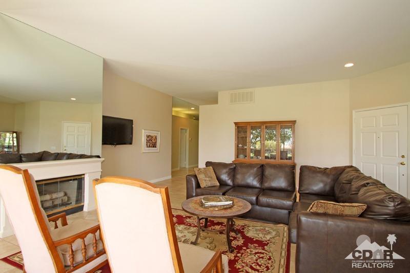 56 Oak Tree Drive Rancho Mirage, CA 92270 - Photo 9 of 32 a living room with furniture a flat screen tv and a fireplace