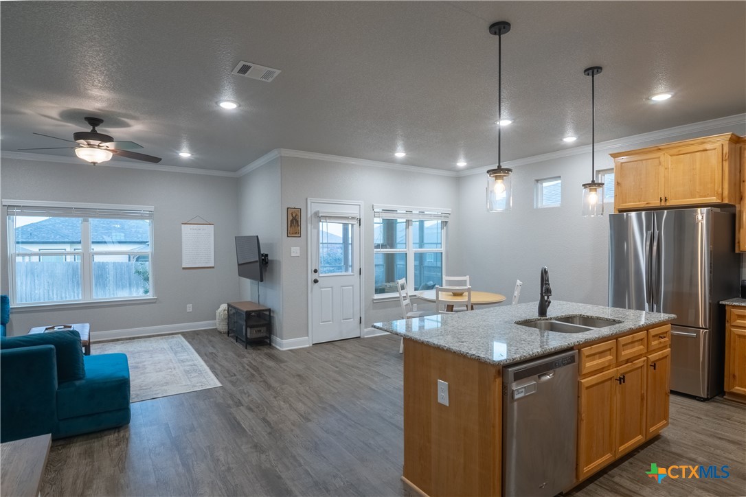 7909 McCulloch Road Temple, TX 76502 - Photo 21 of 46 a kitchen with kitchen island a counter top space a sink appliances and cabinets