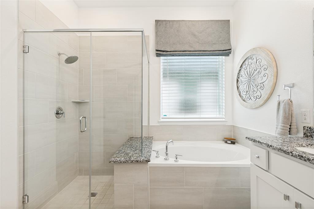 229 Savannah Lane Oak Point, TX 75068 - Photo 15 of 26 a bathroom with a granite countertop bathtub shower and a sink