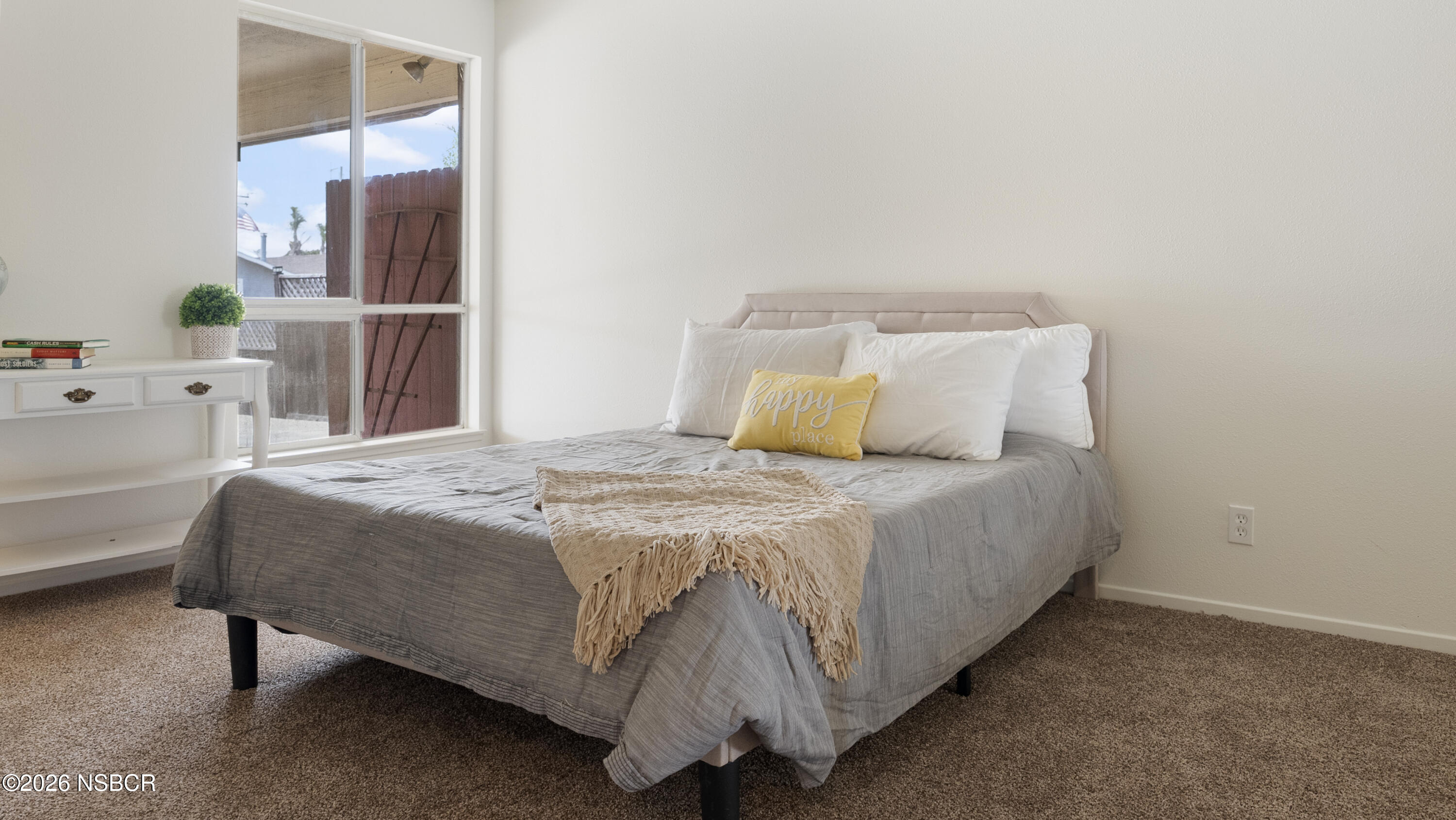 1312 North First Place Lompoc, CA 93436 - Photo 25 of 38 a bedroom with a bed and a table