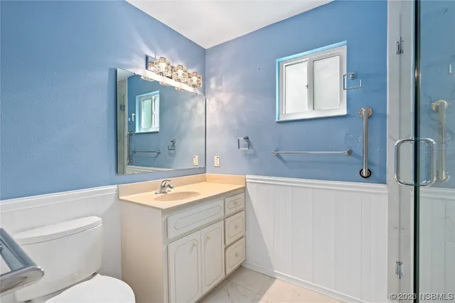 a bathroom with a sink a toilet and mirror