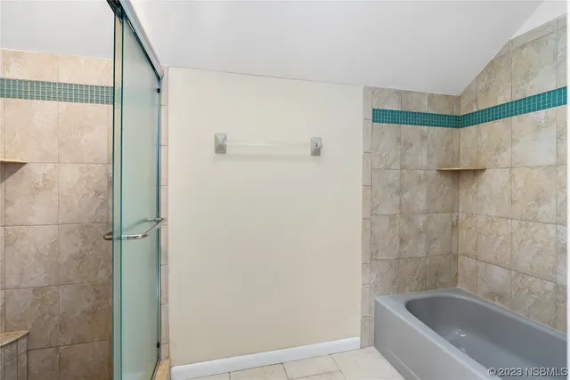 a bathroom with a bathtub and shower