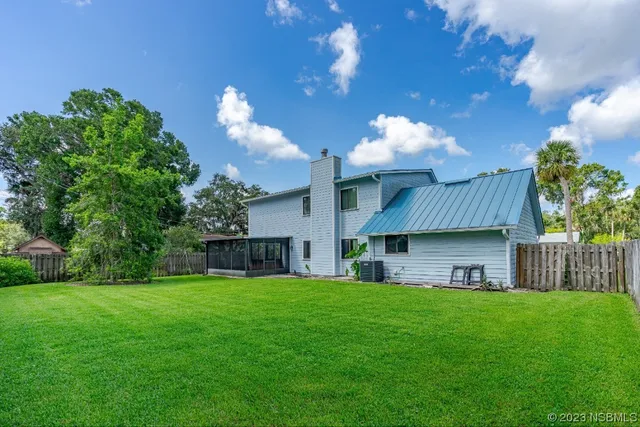 a view of a house with a back yard