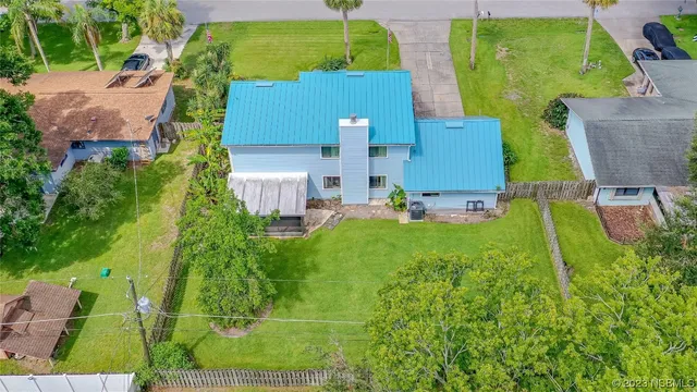 an aerial view of a house with a yard basket ball court and outdoor seating