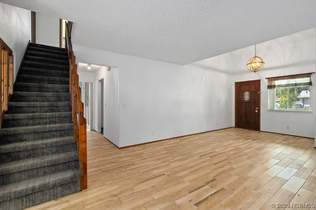 a view of an entryway with wooden floor
