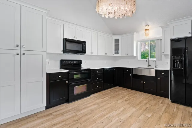 a kitchen with a sink and stainless steel appliances