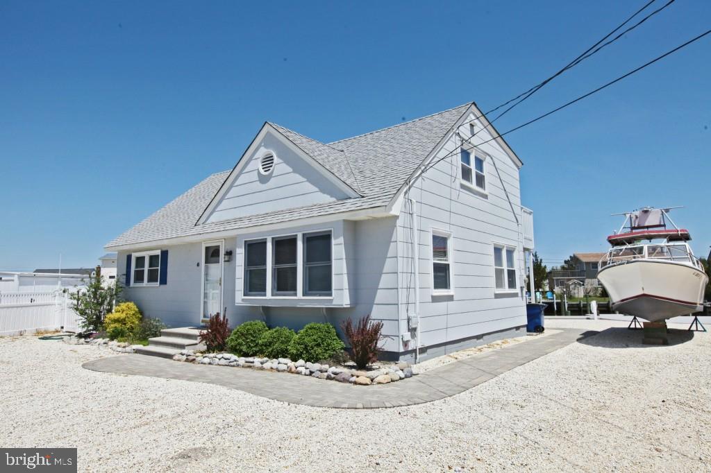 45 Alma Road Long Beach Township, NJ 08006 - Photo 1 of 29 a front view of a house with a garden