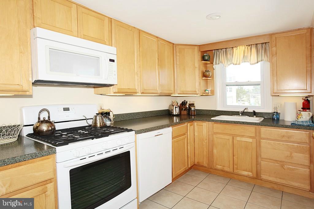 45 Alma Road Long Beach Township, NJ 08006 - Photo 12 of 29 a kitchen with granite countertop a stove sink and cabinets