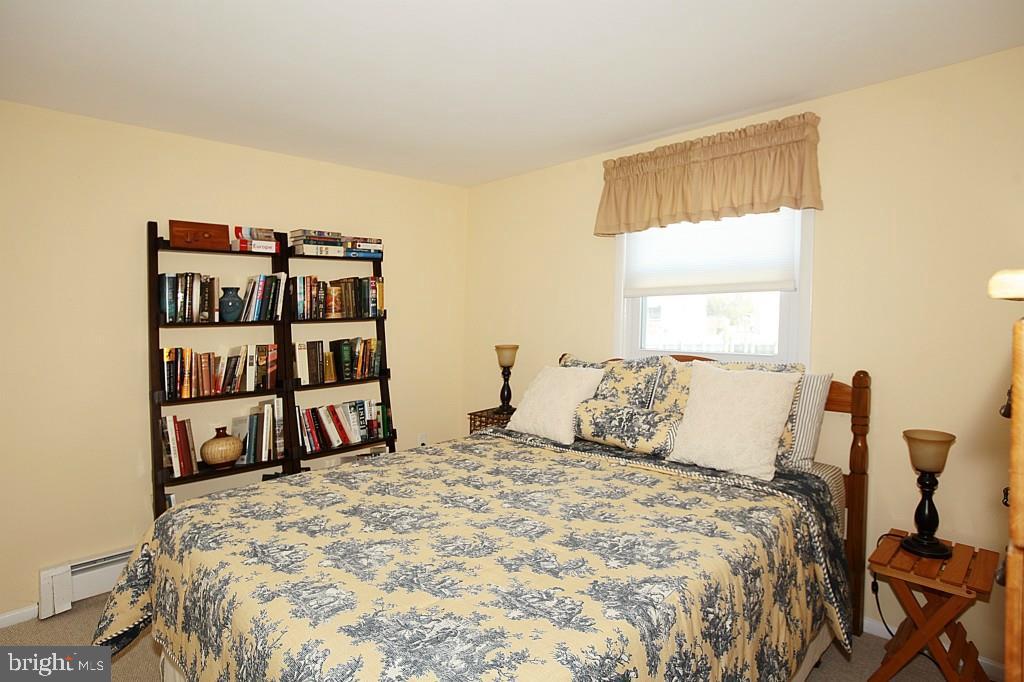 45 Alma Road Long Beach Township, NJ 08006 - Photo 22 of 29 a bedroom with a bed and a book shelf