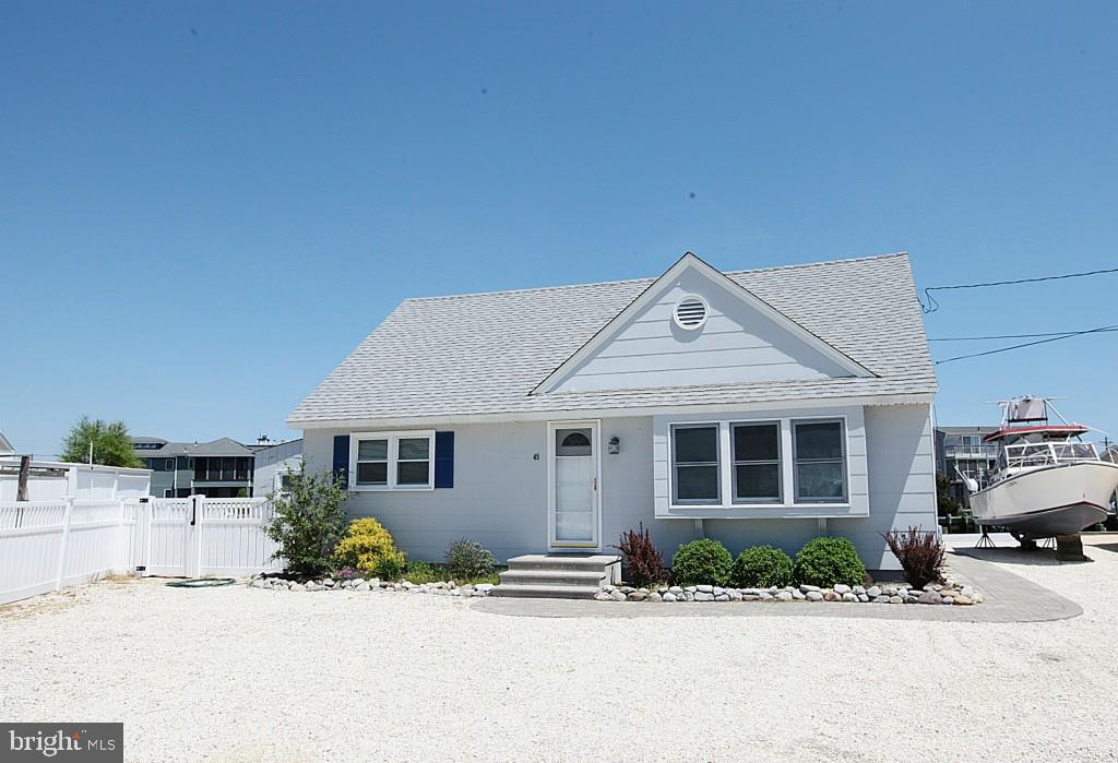 45 Alma Road Long Beach Township, NJ 08006 - Photo 27 of 29 a front view of a house with a yard