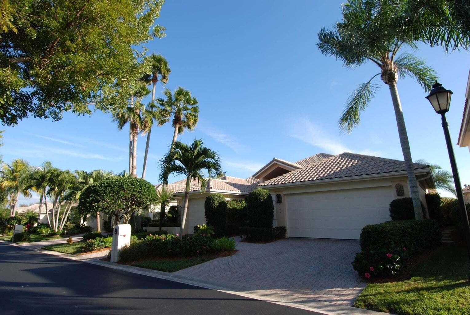 3446 Southern Cay Drive Jupiter, FL 33477 - Photo 1 of 15 a front view of a house with garden