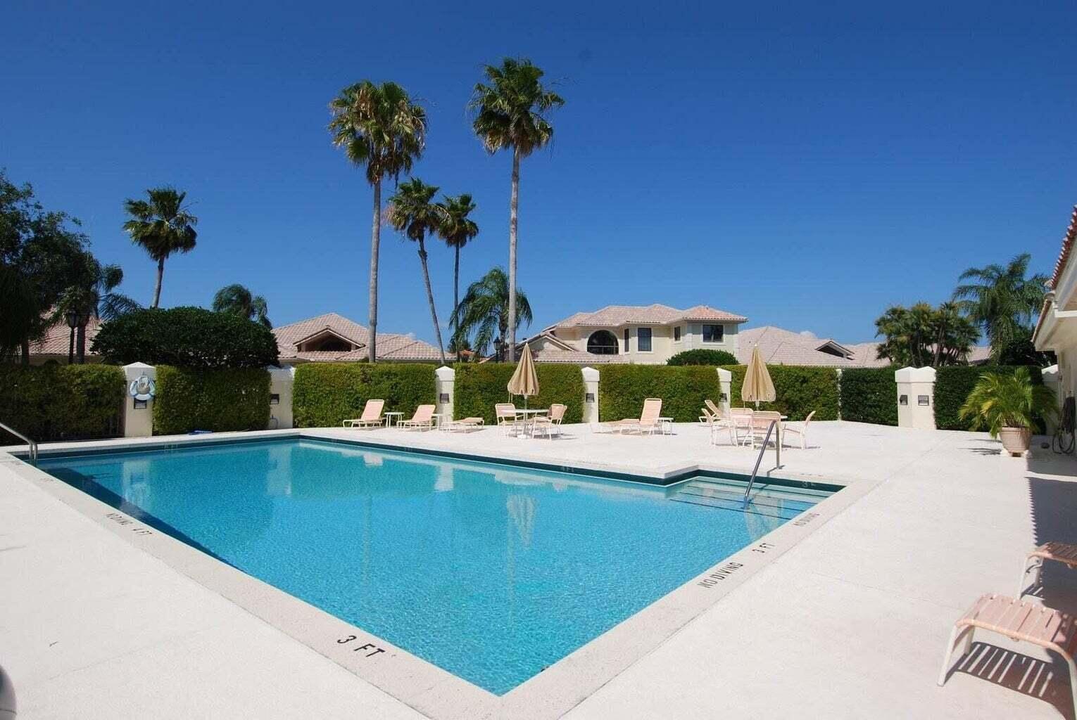 3446 Southern Cay Drive Jupiter, FL 33477 - Photo 15 of 15 a view of a swimming pool with a bench and potted plants