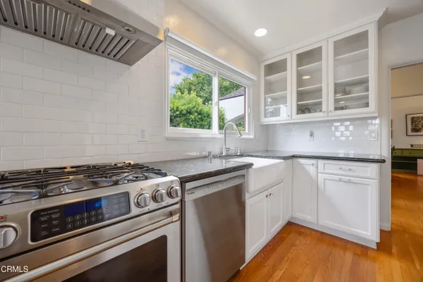 a kitchen with stainless steel appliances granite countertop a stove and a sink