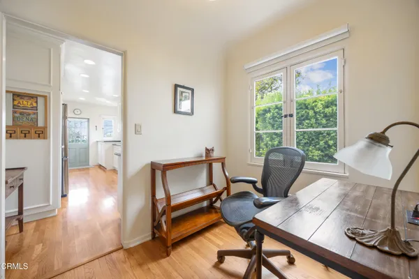 a view of a workspace with furniture and a window