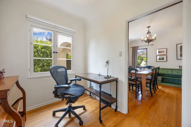 a view of a workspace with furniture and a window