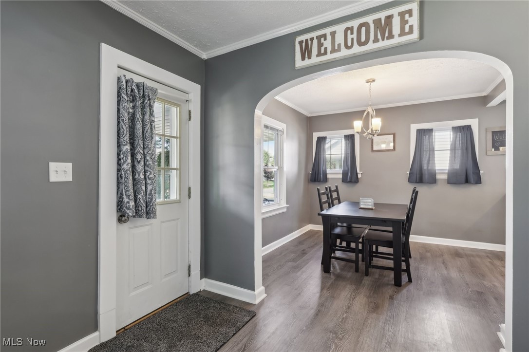 1567 Roselawn Road Cleveland, OH 44124 - Photo 2 of 29 Entryway with crown molding, dark wood-type flooring, an inviting chandelier, and a wealth of natural light