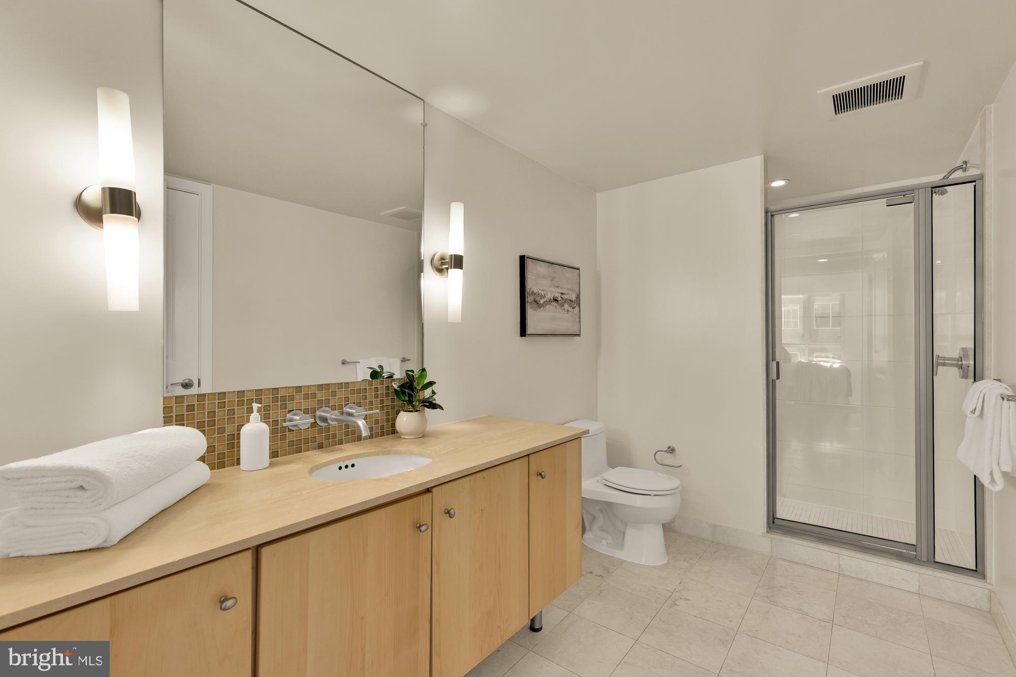 1025 First Street Southeast, Unit 510 Washington, DC 20003 - Photo 11 of 25 A large vanity and shower in the primary suite.