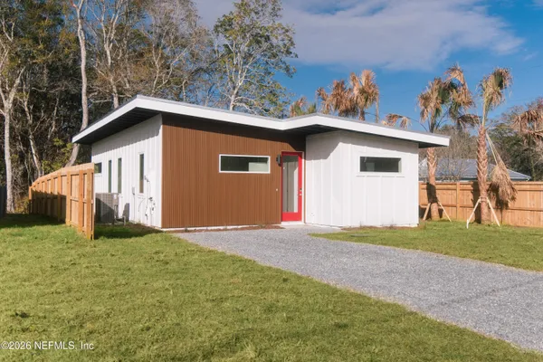 a view of a house with a yard and garage