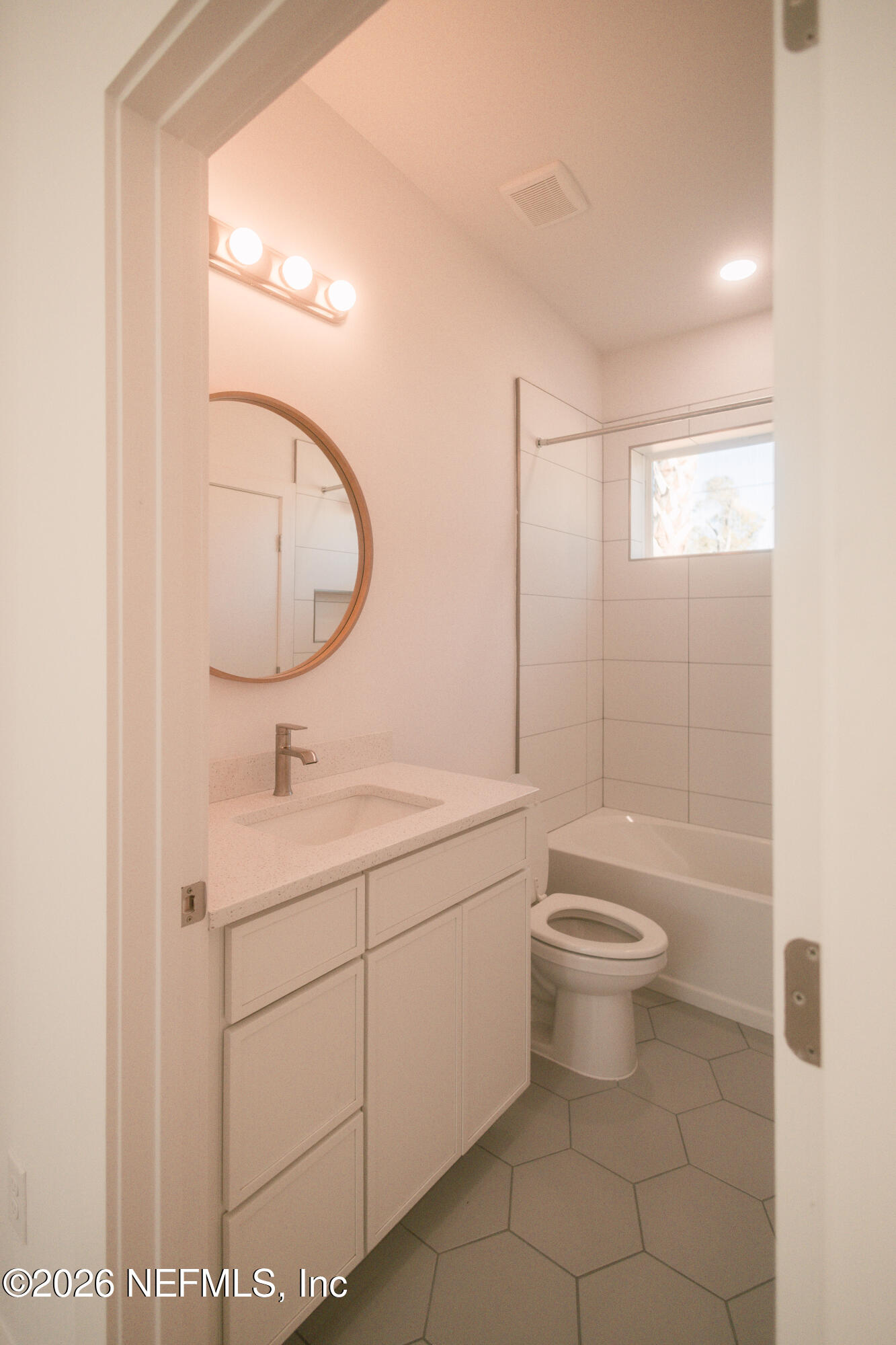 572 Woodlawn Road St. Augustine, FL 32084 - Photo 11 of 15 a bathroom with a toilet a sink and mirror