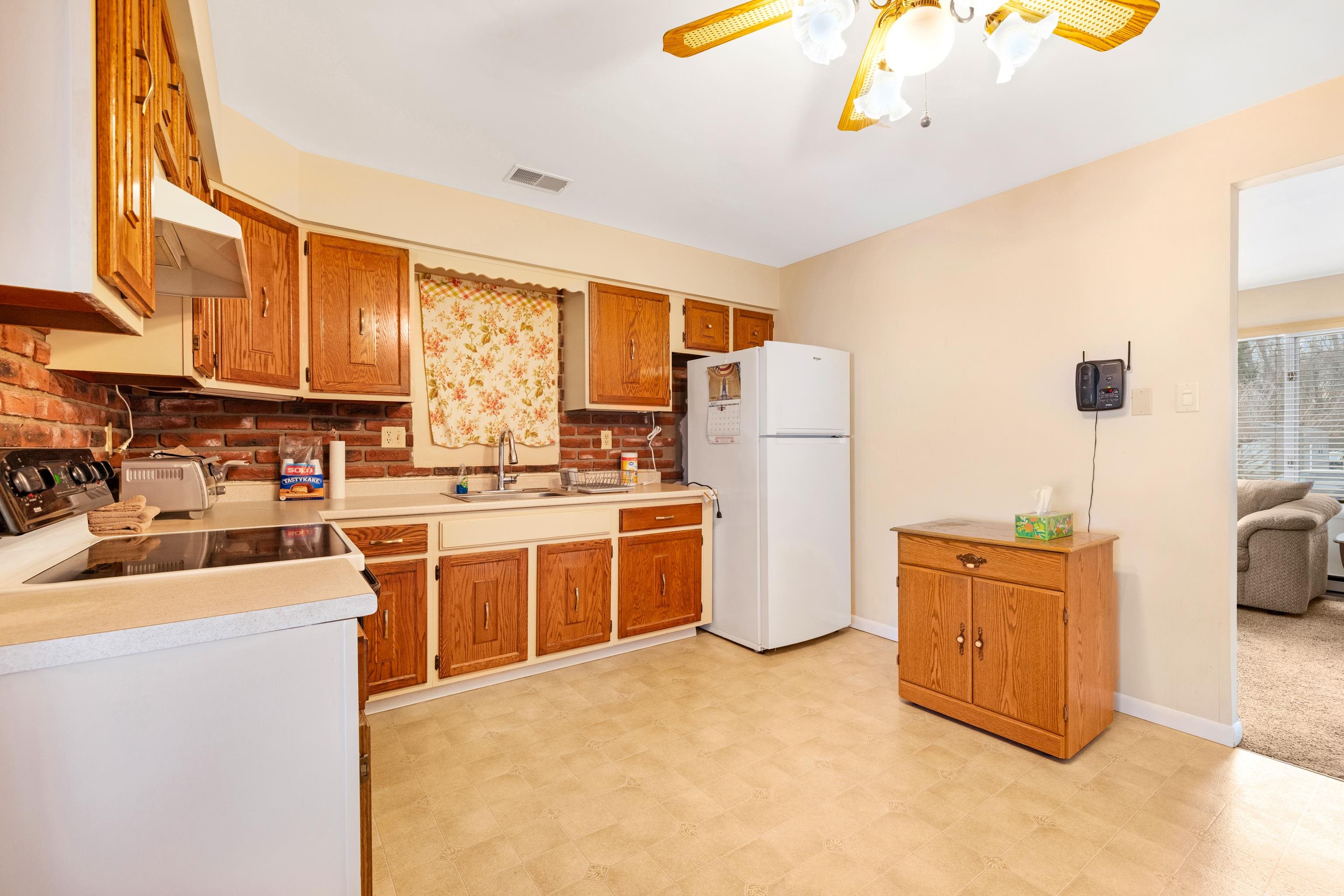 315 East Drumbed Road Villas, NJ 08251 - Photo 9 of 32 a kitchen with a refrigerator a stove a sink dishwasher and wooden cabinets with wooden floor