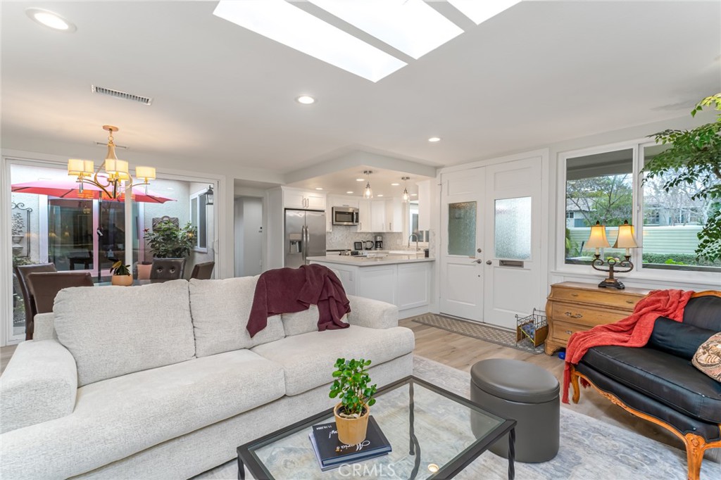 74 Calle Aragon, Unit B Laguna Woods, CA 92637 - Photo 1 of 22 a living room with furniture and a large window
