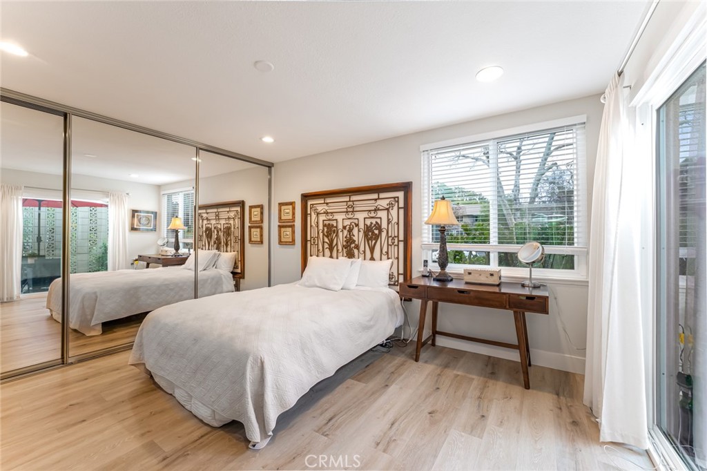 74 Calle Aragon, Unit B Laguna Woods, CA 92637 - Photo 13 of 22 a bedroom with two beds and a large window