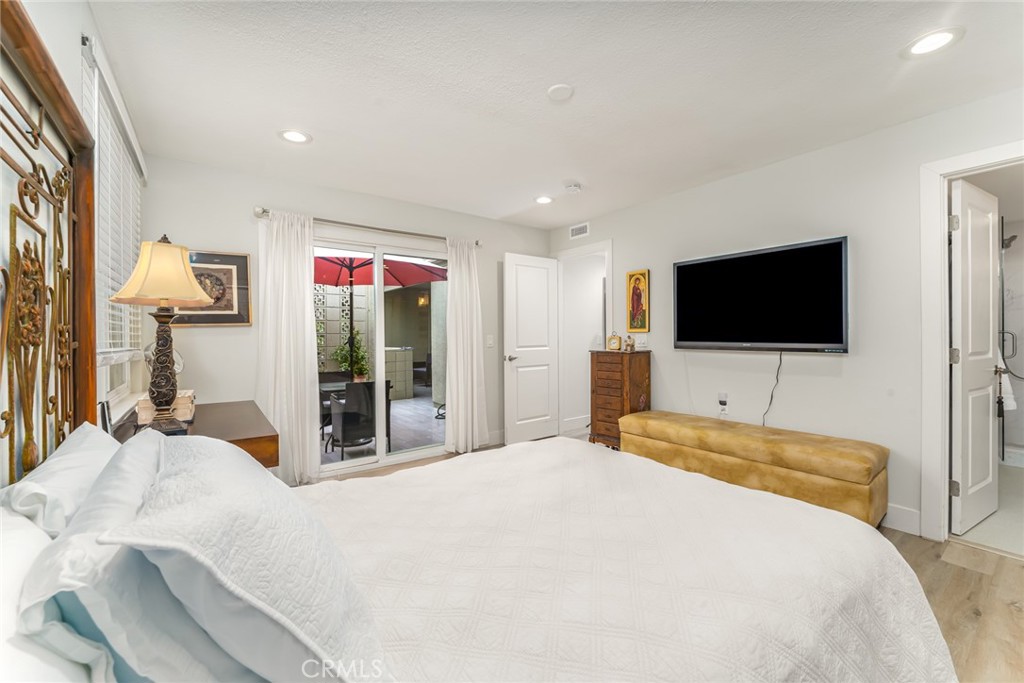 74 Calle Aragon, Unit B Laguna Woods, CA 92637 - Photo 14 of 22 a bedroom with a bed and a flat screen tv