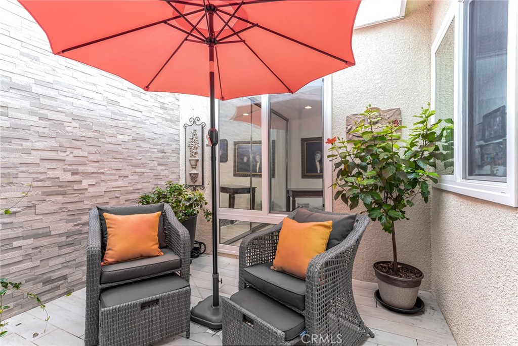 74 Calle Aragon, Unit B Laguna Woods, CA 92637 - Photo 20 of 22 a backyard of a house with seating space
