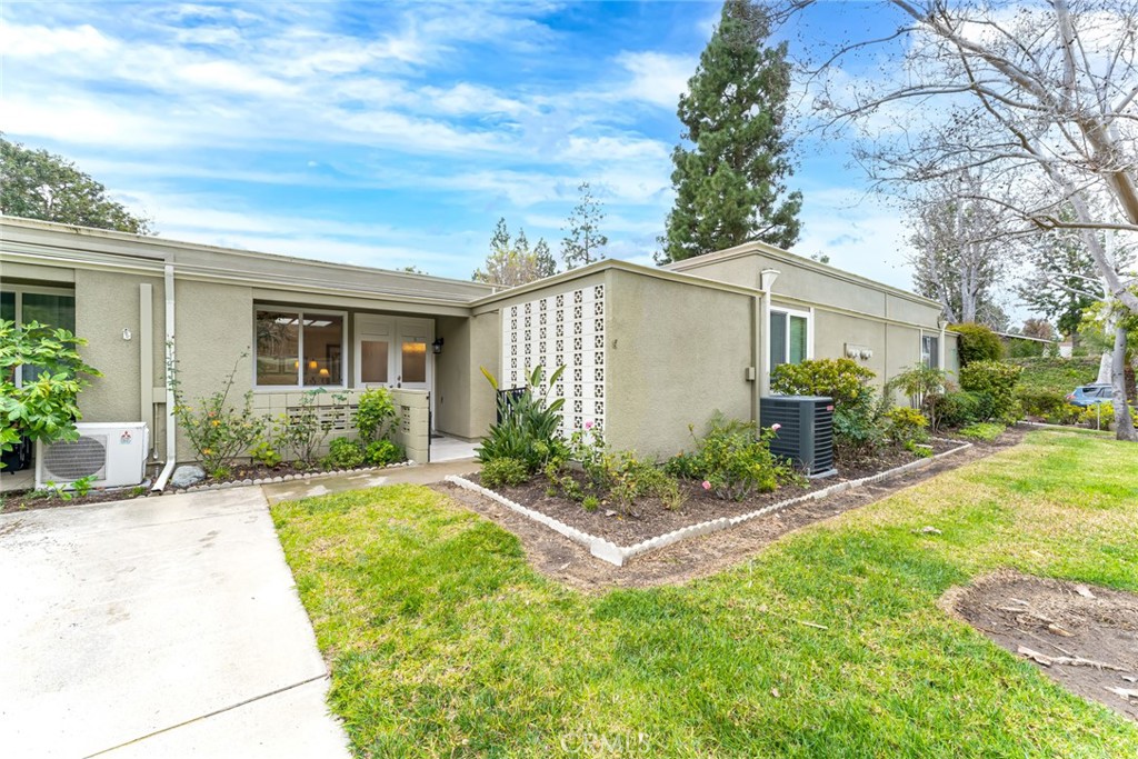 74 Calle Aragon, Unit B Laguna Woods, CA 92637 - Photo 3 of 22 a view of a house with backyard